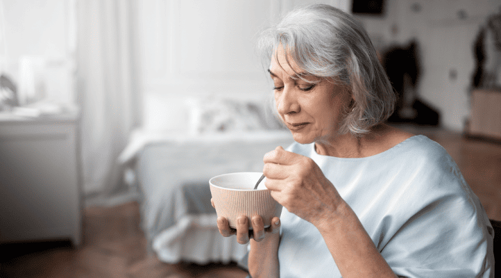 aged woman eating her healthy meal in a bowl