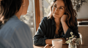 two people share warm eye contact during a cafe conversation